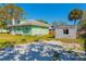 Exterior back of home featuring extra parking, an outside building, and a well-manicured lawn at 313 Jefferson S Ave, Oldsmar, FL 34677