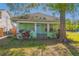 Charming single-story home with a cozy porch and mature landscaping at 313 Jefferson S Ave, Oldsmar, FL 34677