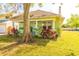 Charming home featuring a cozy front porch, vibrant landscaping, and a welcoming entrance at 313 Jefferson S Ave, Oldsmar, FL 34677
