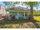 Charming single-story home with a cozy porch and mature landscaping at 313 Jefferson S Ave, Oldsmar, FL 34677