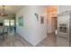 Hallway with stainless steel refrigerator, wood-look laminate flooring, and decorative artwork at 313 Jefferson S Ave, Oldsmar, FL 34677