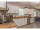 Kitchen with granite countertops, white cabinets, stainless steel appliances, and modern flooring at 313 Jefferson S Ave, Oldsmar, FL 34677