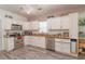 Kitchen with stainless steel appliances and wood-look laminate flooring at 313 Jefferson S Ave, Oldsmar, FL 34677