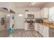 Bright kitchen with stainless steel appliances, light countertops, and wood-look laminate flooring at 313 Jefferson S Ave, Oldsmar, FL 34677