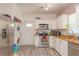 Charming kitchen featuring stainless steel appliances, bright cabinets, and wood-look laminate floors at 313 Jefferson S Ave, Oldsmar, FL 34677