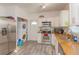 Kitchen with laundry area features stainless steel appliances and granite countertops at 313 Jefferson S Ave, Oldsmar, FL 34677