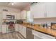 Well-equipped kitchen featuring granite counters, modern appliances and white cabinetry at 313 Jefferson S Ave, Oldsmar, FL 34677