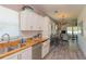 Open concept kitchen with granite countertops, stainless steel appliances, and view of living area at 313 Jefferson S Ave, Oldsmar, FL 34677