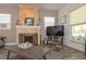Cozy living room featuring a stone fireplace and lots of natural light at 313 Jefferson S Ave, Oldsmar, FL 34677