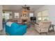 Inviting living room featuring comfortable seating, a stone fireplace, and ample natural light at 313 Jefferson S Ave, Oldsmar, FL 34677