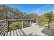 Back porch featuring wood floors, gray rails, and a picturesque view of the grounds at 3327 Pineview Dr, Holiday, FL 34691