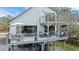 Outdoor dining and lounge seating set on a multi-level backyard deck at 3327 Pineview Dr, Holiday, FL 34691