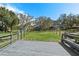 Expansive backyard with a charming wooden deck, offering a serene and private outdoor space at 3327 Pineview Dr, Holiday, FL 34691