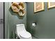 Modern bathroom with a white toilet, hexagon shelves, and neutral paint, creating a serene atmosphere at 3327 Pineview Dr, Holiday, FL 34691