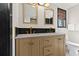 Bathroom features a double sink vanity with gold fixtures, black tile backsplash and a window for natural light at 3327 Pineview Dr, Holiday, FL 34691