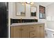 Bathroom with double sink vanity, modern fixtures, and black tile accents at 3327 Pineview Dr, Holiday, FL 34691