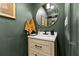 Stylish powder room with a new vanity, round mirror, and updated fixtures, exuding modern elegance at 3327 Pineview Dr, Holiday, FL 34691