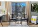 Sunlit bedroom features a ceiling fan, workspace, natural light and access to outdoor balcony with scenic views at 3327 Pineview Dr, Holiday, FL 34691