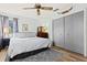 Comfortable bedroom featuring a ceiling fan, hardwood floors, and a spacious closet for ample storage at 3327 Pineview Dr, Holiday, FL 34691