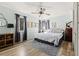 Bright bedroom with a ceiling fan, wood floors, light blue walls, and a stylish rug adding warmth to the space at 3327 Pineview Dr, Holiday, FL 34691