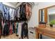 Walk-in closet with ample storage space and wooden dressing table at 3327 Pineview Dr, Holiday, FL 34691