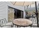 Outdoor deck area featuring a dining set, sliding glass doors, and upper deck at 3327 Pineview Dr, Holiday, FL 34691