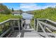 Waterfront dock featuring steps leading down to serene canal with boat access at 3327 Pineview Dr, Holiday, FL 34691