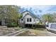 Stilt house with a driveway, boat, and a well-maintained yard and landscaping at 3327 Pineview Dr, Holiday, FL 34691