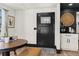 Hallway featuring dark door, rattan accent, coffee bar and contrasting wall colors at 3327 Pineview Dr, Holiday, FL 34691