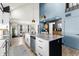 Open-concept kitchen with marble island, stainless appliances, and adjacent dining area with natural light at 3327 Pineview Dr, Holiday, FL 34691
