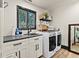 Functional laundry room with modern appliances, black countertops, and stylish decor for convenient chores at 3327 Pineview Dr, Holiday, FL 34691