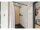 Spa-like shower with modern gold fixtures, stylish tile and adjacent walk-in closet at 3327 Pineview Dr, Holiday, FL 34691