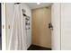 Luxurious shower featuring a wooden tile wall accent, gold fixtures and hardware at 3327 Pineview Dr, Holiday, FL 34691