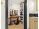 Bright walk-in closet boasts built-in shelving, mirrored vanity, with wood floors in this well designed home at 3327 Pineview Dr, Holiday, FL 34691