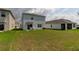 Expansive backyard with lush lawn, privacy fence, and patio area perfect for entertaining at 34110 Jasper Stone Dr, Wesley Chapel, FL 33543