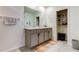 Bathroom featuring double sink vanity with gray cabinetry, modern hardware, and a framed mirror over the countertop at 34110 Jasper Stone Dr, Wesley Chapel, FL 33543