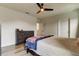 Bedroom featuring neutral décor, a ceiling fan, and dresser and door leading to other rooms at 34110 Jasper Stone Dr, Wesley Chapel, FL 33543
