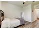 Comfortable bedroom featuring wood-look floors, a bed and a mirror at 34110 Jasper Stone Dr, Wesley Chapel, FL 33543