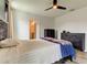 Bedroom featuring stylish furnishings, a ceiling fan, and a door leading to the en-suite bathroom at 34110 Jasper Stone Dr, Wesley Chapel, FL 33543