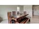 Chic dining area with a wooden table and bench seating near the kitchen at 34110 Jasper Stone Dr, Wesley Chapel, FL 33543