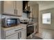 Kitchen with gray cabinets, stainless steel appliances, countertop, and white subway tile backsplash at 34110 Jasper Stone Dr, Wesley Chapel, FL 33543