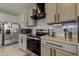 Kitchen with gray cabinets, stainless steel appliances, countertop, and white subway tile backsplash at 34110 Jasper Stone Dr, Wesley Chapel, FL 33543
