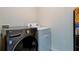 Laundry room features a front loading washer, a top loading dryer, and ample space for organizing laundry supplies at 34110 Jasper Stone Dr, Wesley Chapel, FL 33543