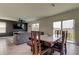 Open-concept living and dining area with sliding glass doors to the outdoor patio for seamless indoor/outdoor living at 34110 Jasper Stone Dr, Wesley Chapel, FL 33543