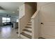 Staircase view that leads into the living room and kitchen area with tiled floors at 34110 Jasper Stone Dr, Wesley Chapel, FL 33543