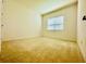 Bedroom with carpet floors, bright window and neutral walls at 3444 Acacia Bay Ave, Wesley Chapel, FL 33543