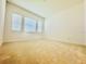 A brightly lit bedroom with carpet flooring and large windows at 3444 Acacia Bay Ave, Wesley Chapel, FL 33543