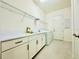 Functional laundry room with built-in cabinets, sink, and modern appliances at 3444 Acacia Bay Ave, Wesley Chapel, FL 33543