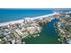 Expansive aerial view of the condominium complex with beach access and waterway docks, providing stunning coastal vistas at 3805 Gulf Blvd # 404, St Pete Beach, FL 33706