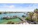 Aerial view of a home on the water with docks and boats, surrounded by lush greenery at 3805 Gulf Blvd # 404, St Pete Beach, FL 33706